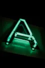 a triangle shaped neon sign sitting on top of a table
